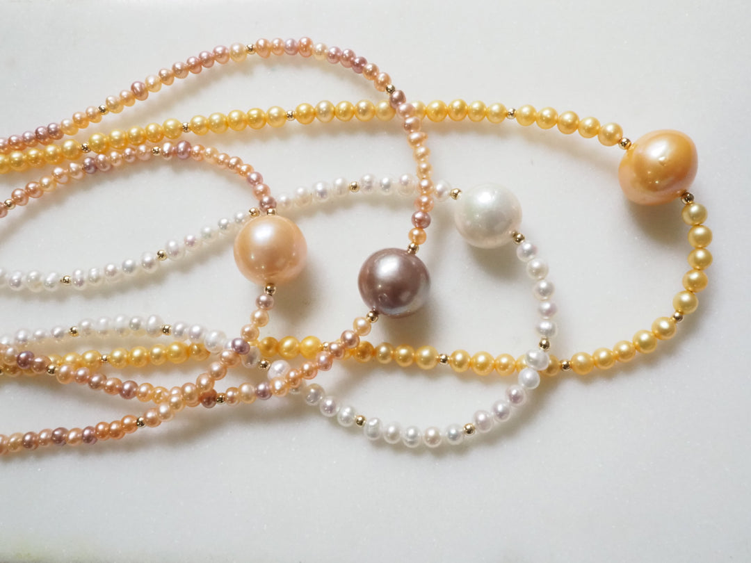South Sea Pearl Choker by Kislap Jewelry: a single white South Sea pearl centered on a strand of small pearls