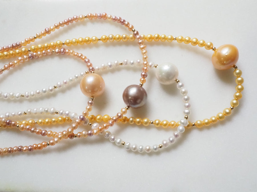South Sea Pearl Choker by Kislap Jewelry: a single white South Sea pearl centered on a strand of small pearls